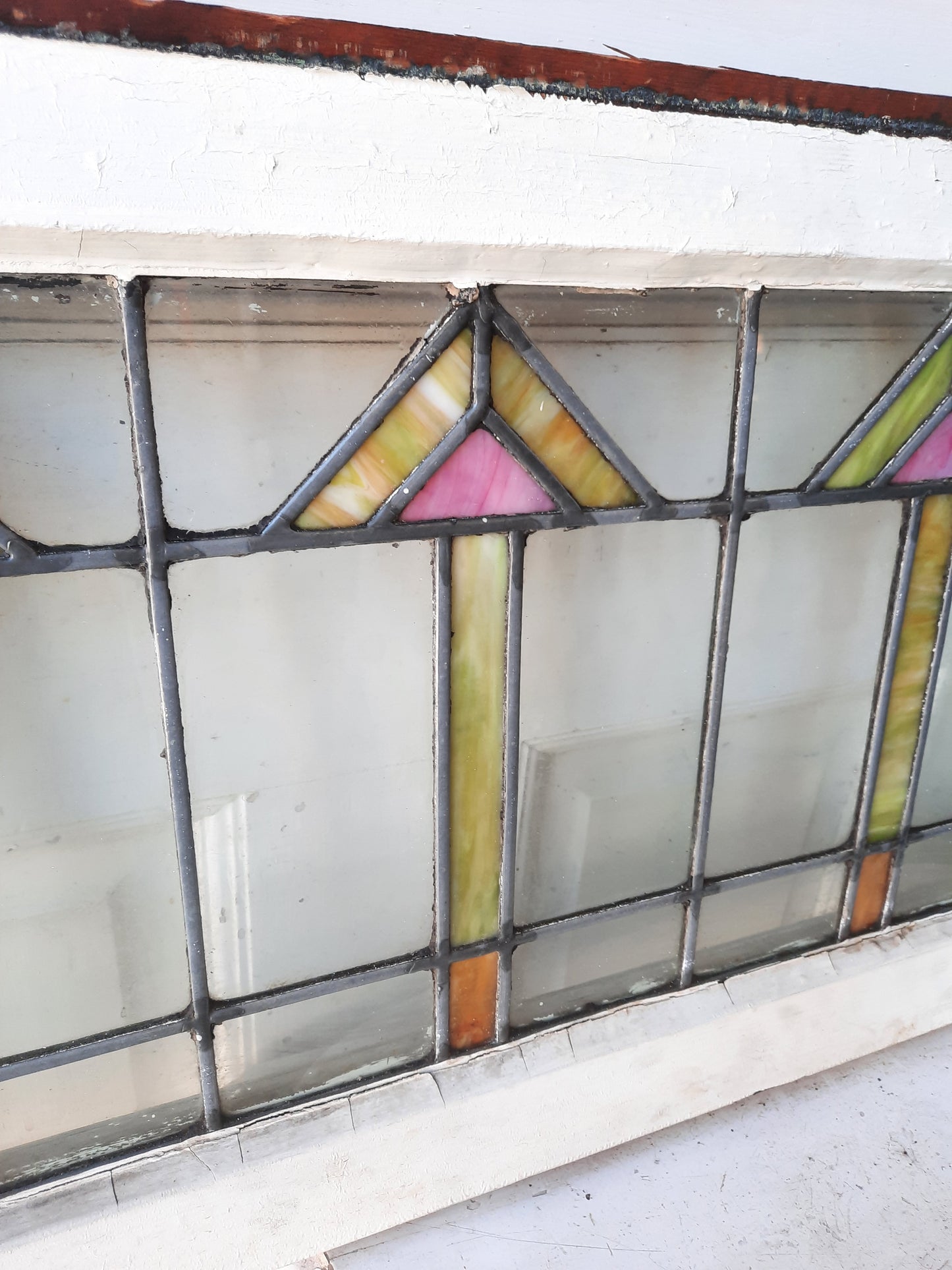 Arts and Crafts Style Stained Glass Window with Pink and Yellow Arrow Design