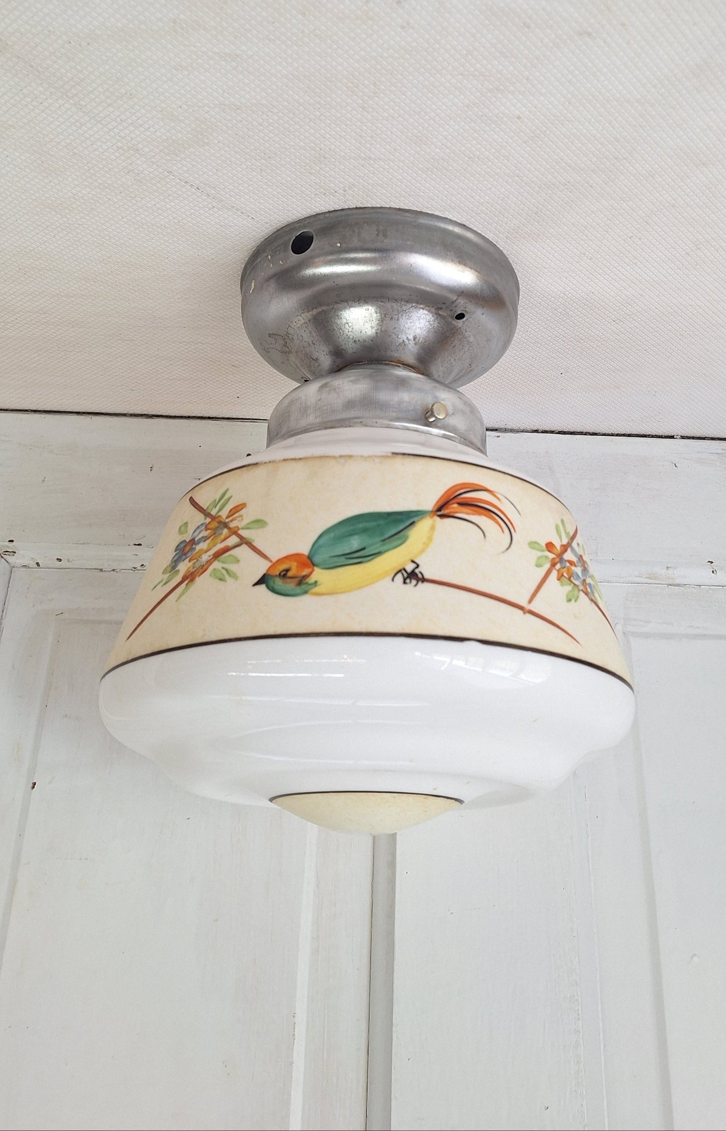 Decorative ceiling light with a bird design on a white background