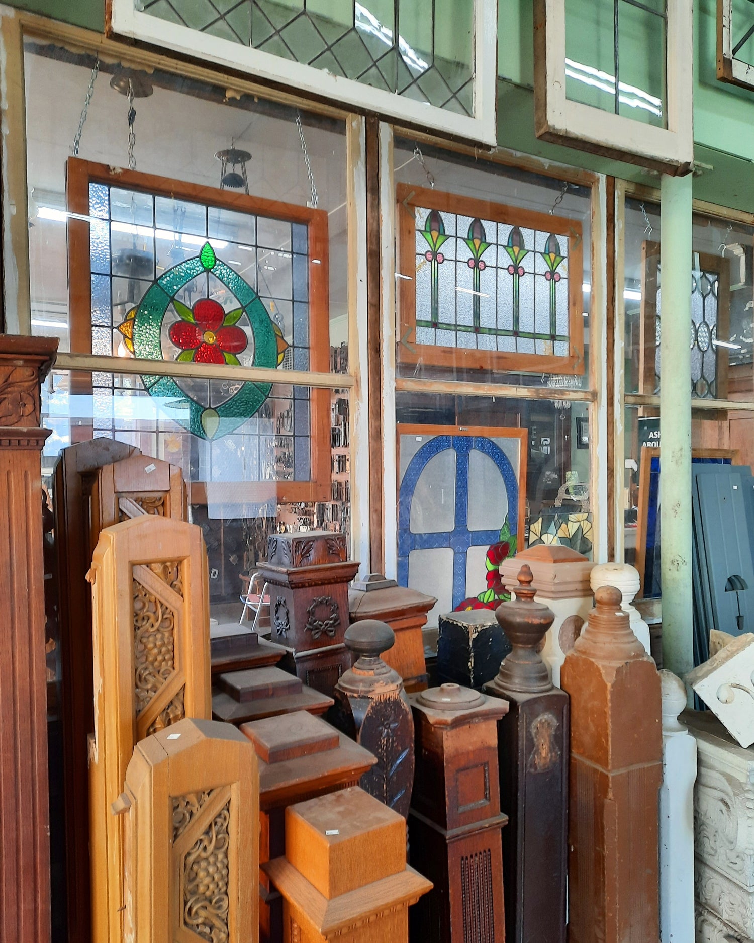 Jewel toned stained glass windows and antique staircase newel posts in a variety of styles. 