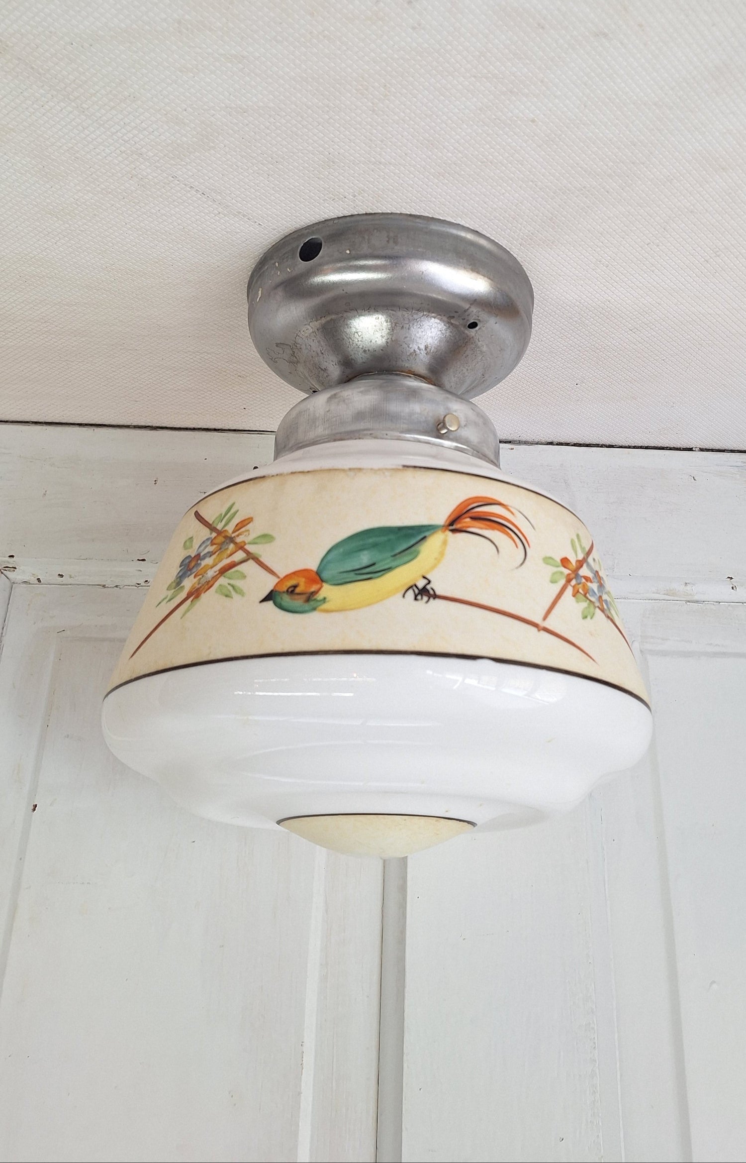 Decorative ceiling light with a bird design on a white background