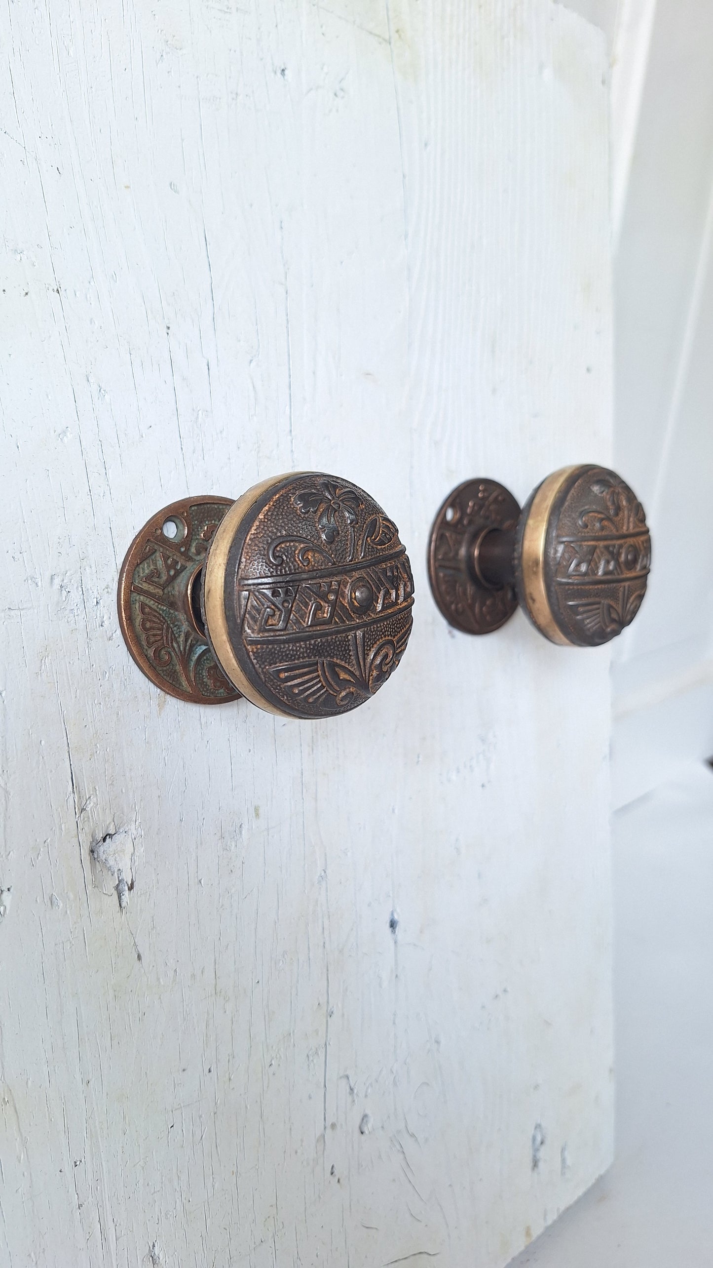 Pair Brass Banded Corbin Doorknobs with Bronze Rosettes