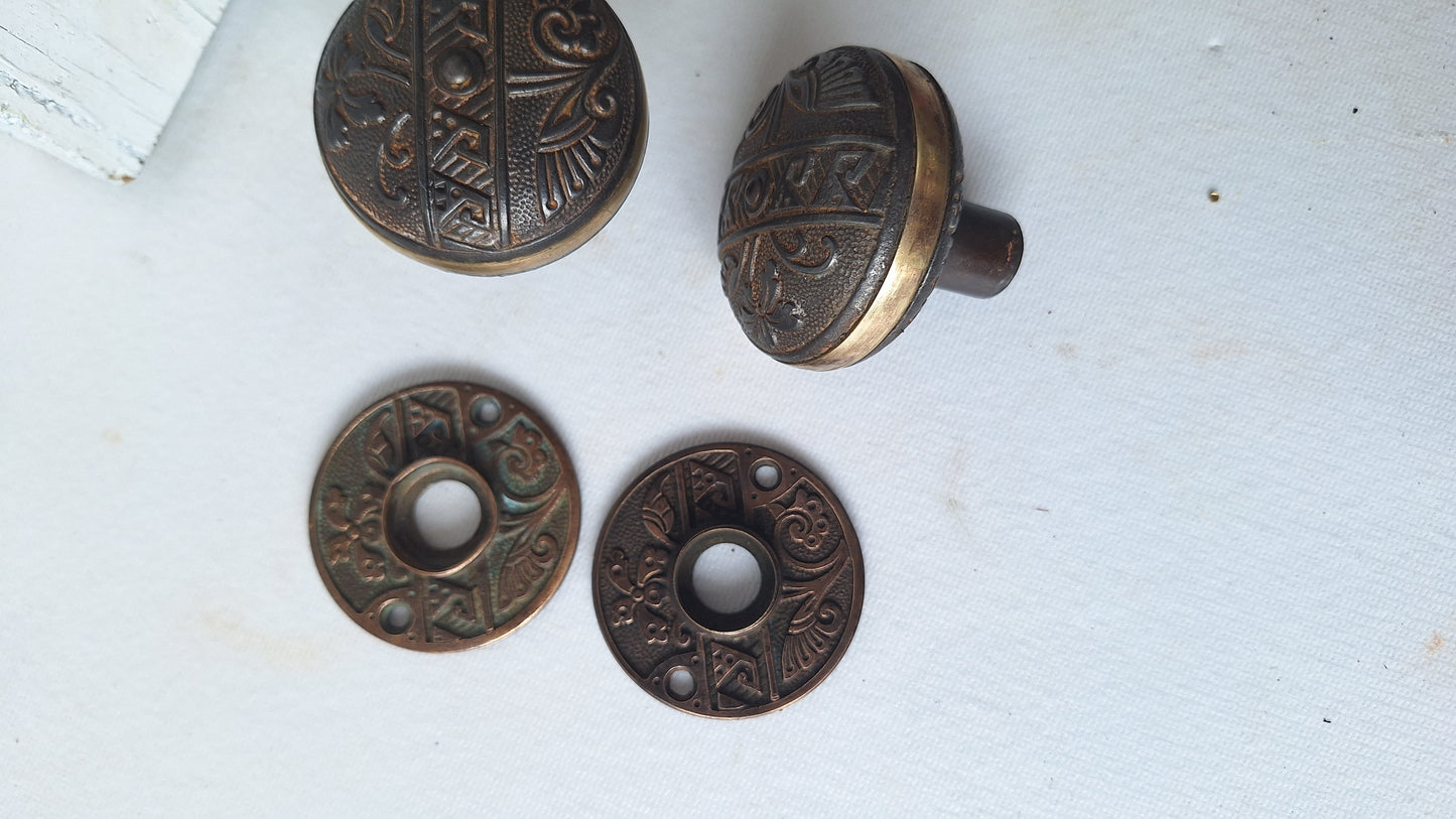 Pair Brass Banded Corbin Doorknobs with Bronze Rosettes